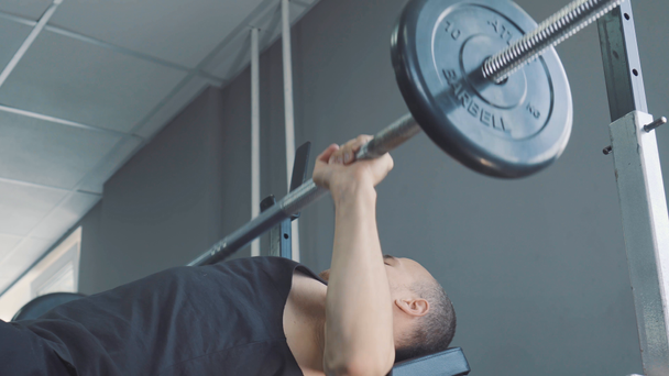 Dumbbells in the gym - muscle training. The man lifts dumbbells in the gym. The rolled big man trains with dumbbells. The trainer in the gym. Lifestyle. - Filmmaterial, Video