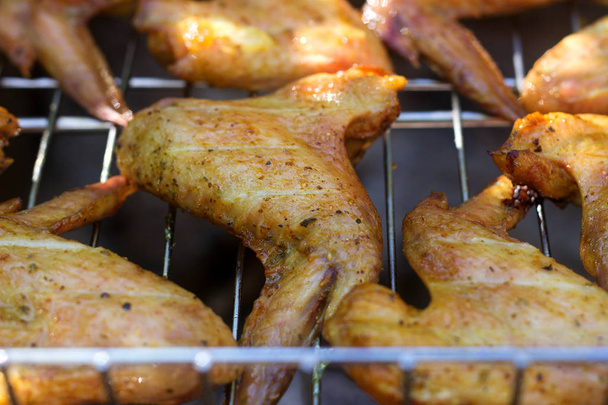 Chicken wings on barbecue grill with fire - Photo, Image