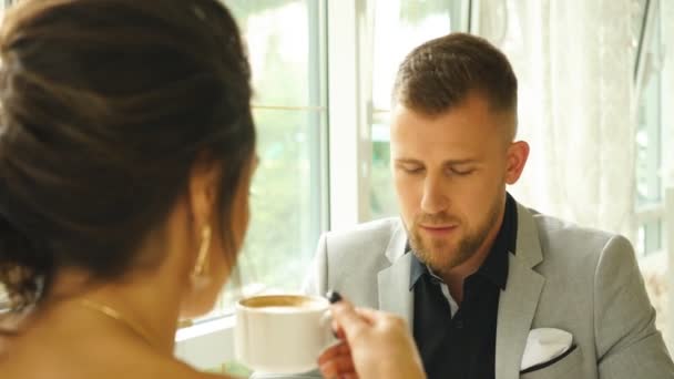 happy handsome man smiling on a date,Happy couple at coffee shop looking at each other - Filmagem, Vídeo