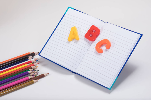 ABC alphabet learning theme with book and pencils - 写真・画像