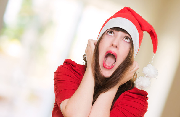 stressed woman wearing a christmas hat - Photo, Image