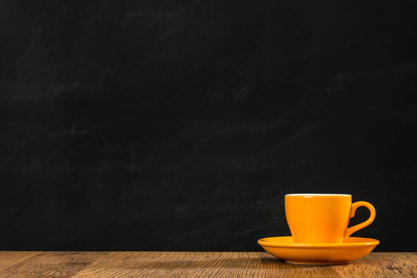 lonely orange tea cup group placed on the black - 写真・画像