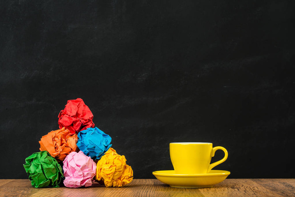 garbage colored paper balls with a yellow cup - Foto, Imagem
