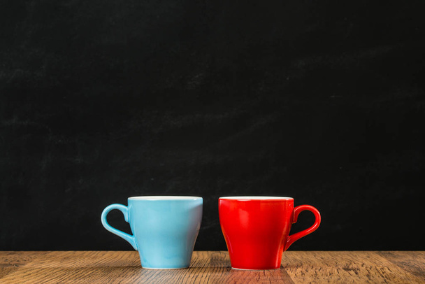 colorful blue and red coffee cups on the ancient wood  - Photo, image