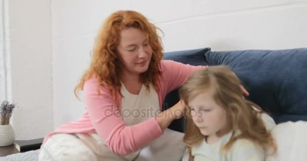 Mother Petting Daughters Head While Girl Using Laptop Computer, Family Sitting On Bed In Bedroom Spend Time Together - Materiał filmowy, wideo