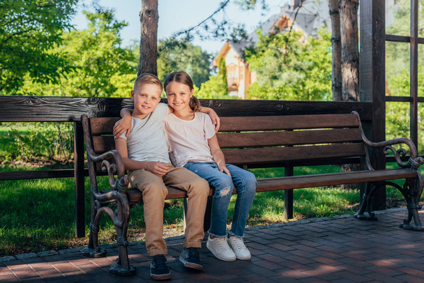 kids sitting on bench in park - Zdjęcie, obraz