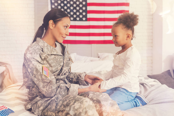 Military mother holding her daughters hands - Fotó, kép