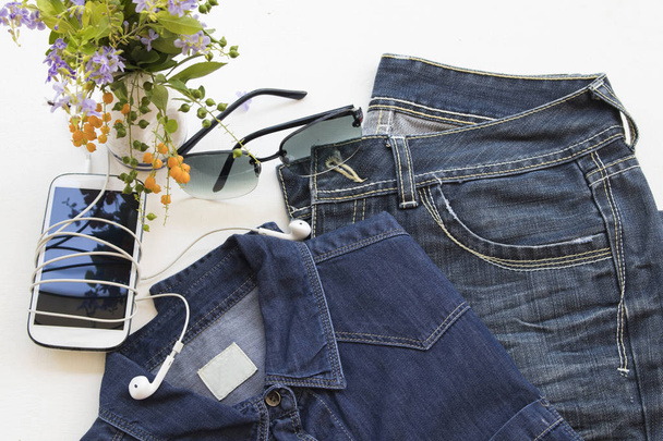 životní styl žena jeans kalhoty a Jeans košile štůček látky na pozadí bílé dřevo - Fotografie, Obrázek