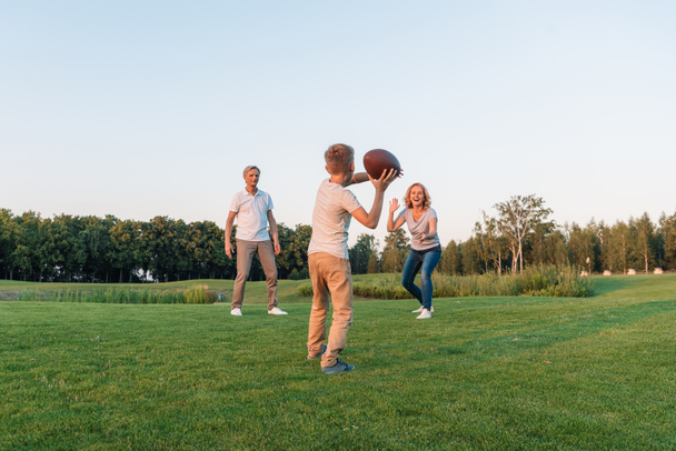 kid playing rugby with grandparents - Photo, Image