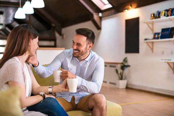 Couple relaxing at home with coffee  - Photo, image