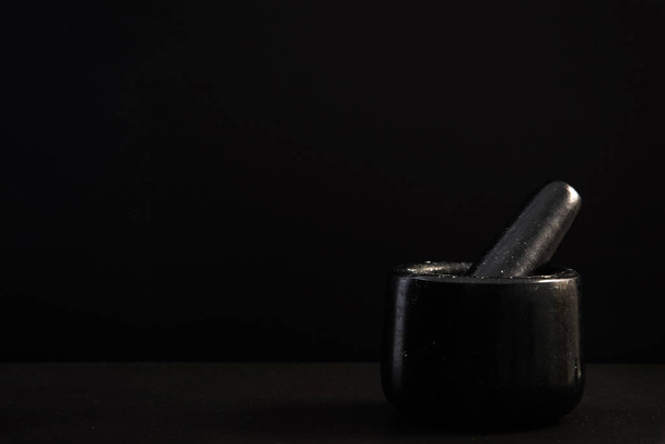 Granite pestle herb mortar on dark stone slate - Valokuva, kuva