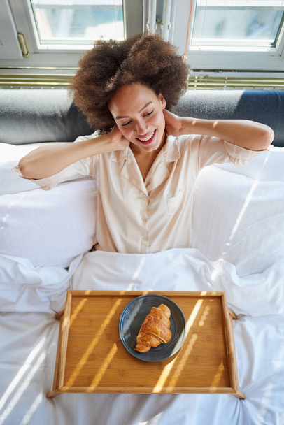 Woman with bed tray sitting in bed - Photo, image