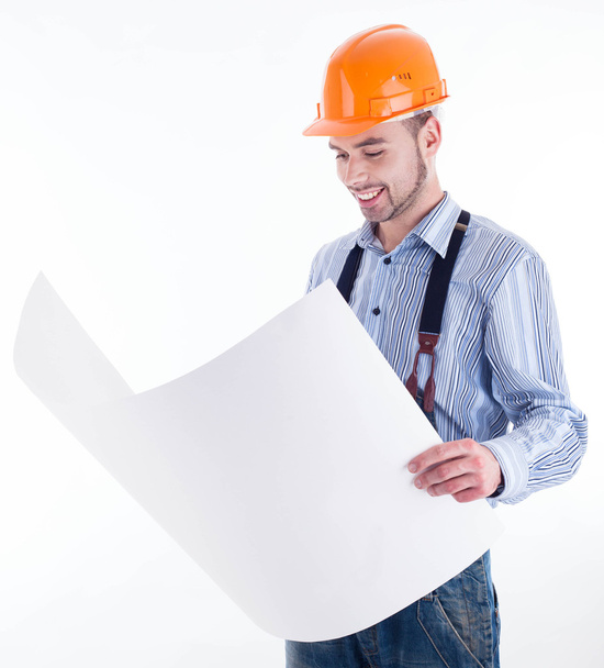 Male architect looking at blueprints against white background - Foto, Bild