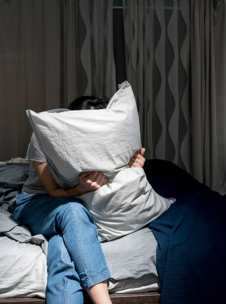 Depresivní žena zakryla tvář s polštářem a křičí - Fotografie, Obrázek