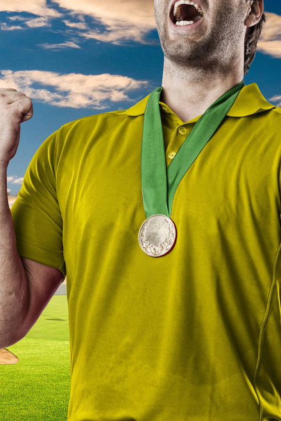 Golf Player in a yellow shirt - 写真・画像