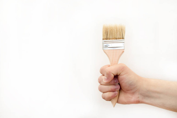 Building brush in hand - Foto, afbeelding