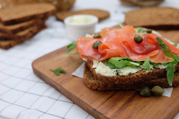 salmon sandwich on white wood background - Photo, Image