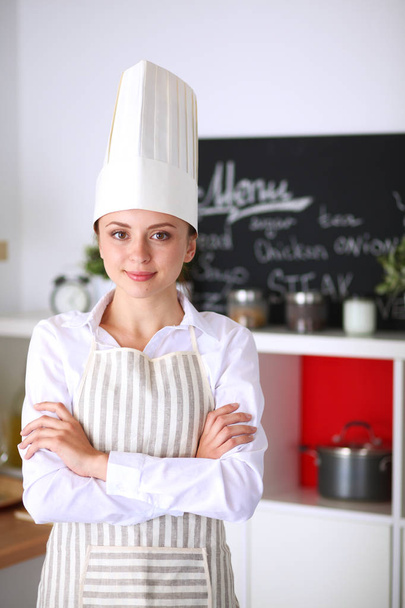 Chef woman portrait with uniform in the kitchen - Foto, afbeelding