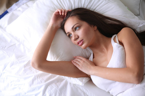 Pretty woman lying in bed at home - Фото, зображення