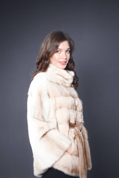 Portrait of a beautiful woman in jacket with fur. - Photo, Image