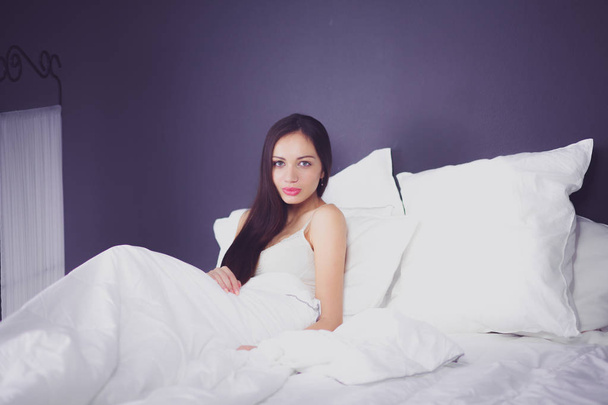 Pretty woman lying in bed at home - Fotografie, Obrázek