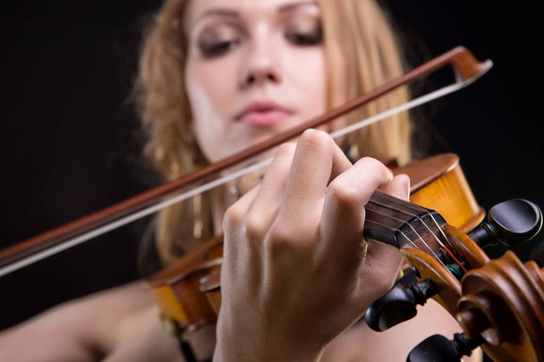 Closeup photo of girl playing the fiddle - Photo, Image