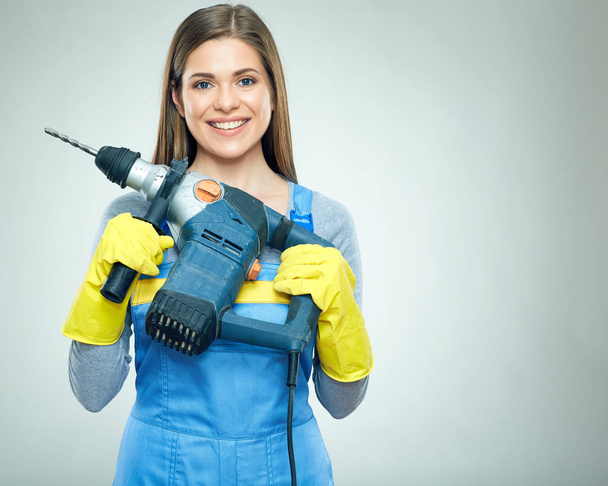 Smiling woman builder holding big puncher - Photo, image