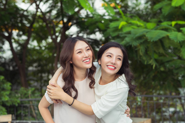 sisters hugging and smiling - Photo, Image