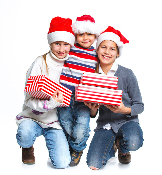 Happy kids in Santa's hat with gift box - 写真・画像