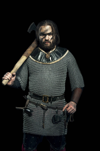 Formidable viking in armor and axe on black background - Photo, Image