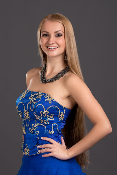 Young beautiful woman in blue dress - Фото, зображення