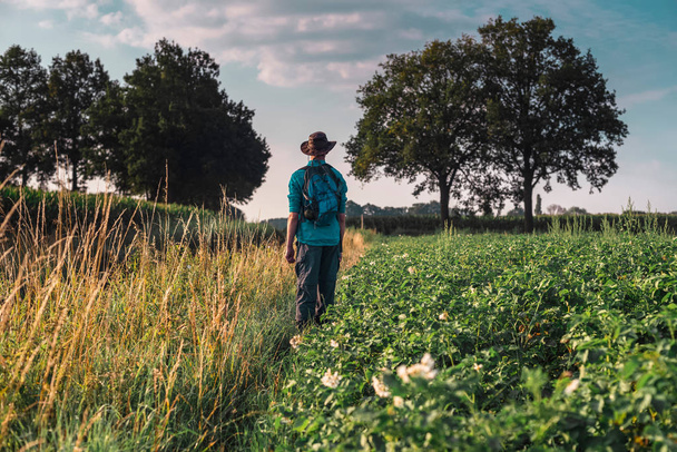 Young man standing in farmland  - Photo, Image