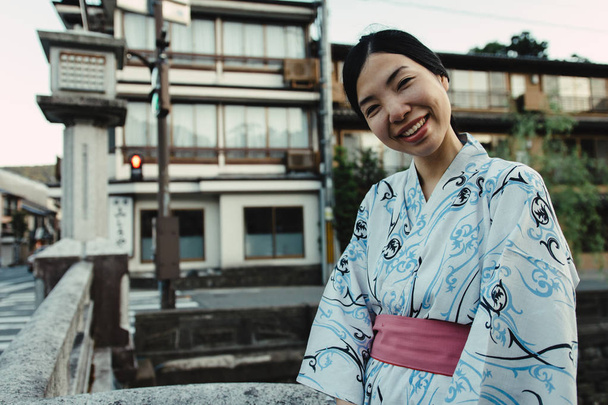 an asian girl smiling and wearing Yukata - Foto, imagen