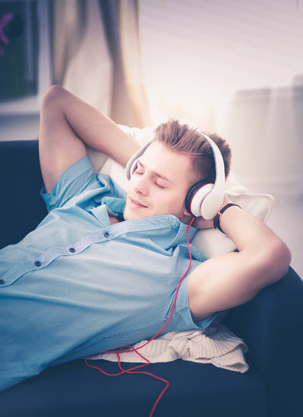Man listening music with headphones at home - Fotó, kép