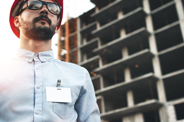 Portrait of young bearded architect man with blank badge or pocket of his shirt - Fotoğraf, Görsel