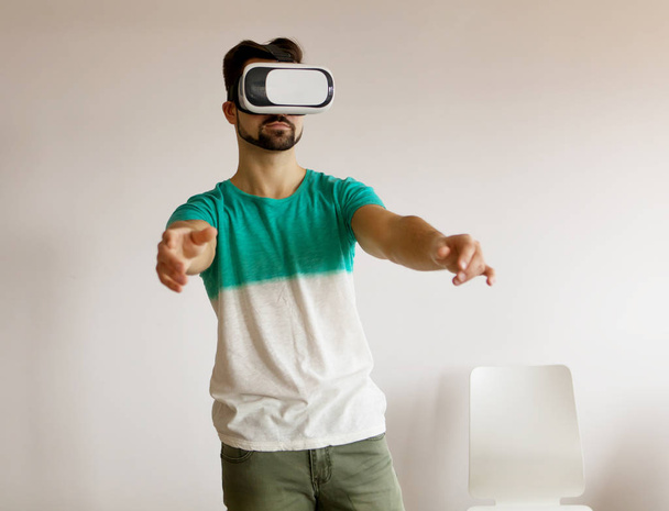 Young bearded man wearing virtual reality. - Photo, image