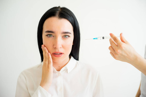 Woman gets facial injection - Fotó, kép