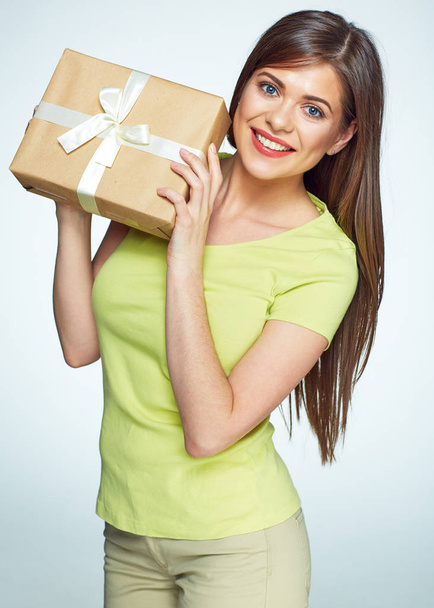 Smmiling woman holding gift box with white stripes. - Foto, immagini