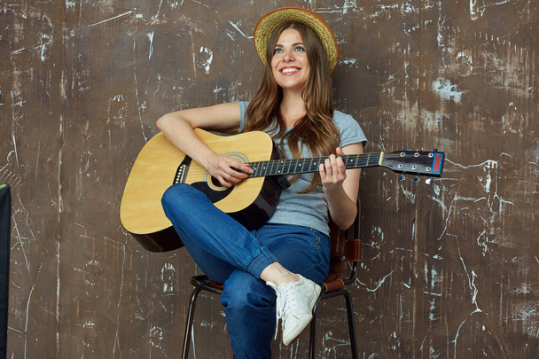 Smiling young woman portrait with acoustic guitar. - Fotografie, Obrázek