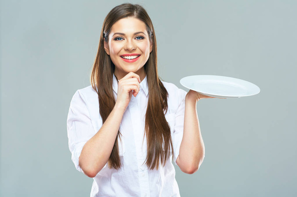 Smiling Business woman  holding emty white plate.  - Fotografie, Obrázek