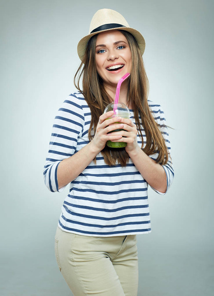 Modern girl wearing hat holding green juice - Foto, Imagem