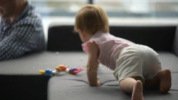 Little toddler crawling on the sofa - Felvétel, videó