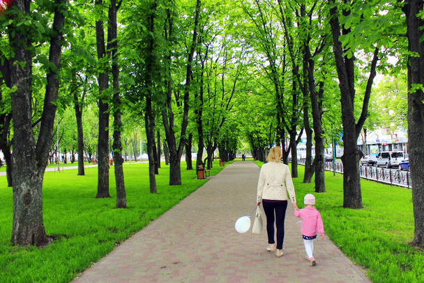 мать и дочь гуляют в городском парке
 - Фото, изображение