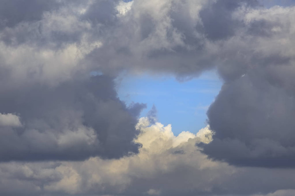 A bit clear blue sky among dark thunderclouds as background - Photo, Image
