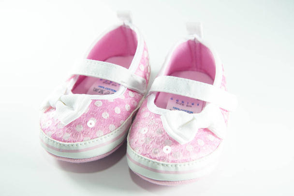 Pink and white children shoes on white background. - Foto, Bild