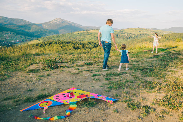 happy family father and child on meadow with a kite - Photo, Image