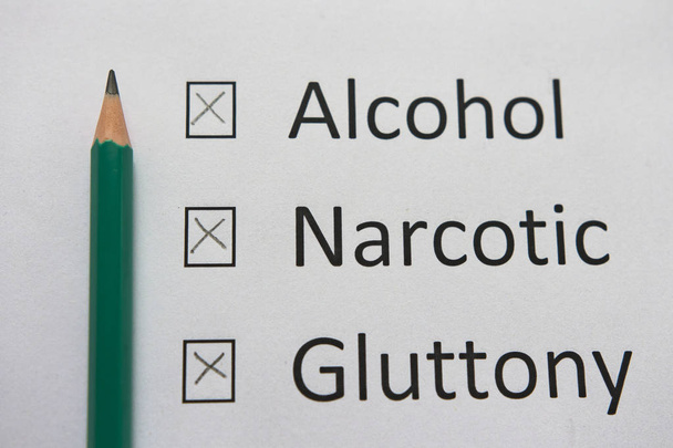 Harmful habits: alcohol, drugs, gluttony are written on white paper in pencil. Get rid of bad habits. - Foto, Imagen