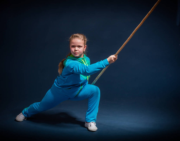 Girl in a blue wear engaged wushu - Photo, Image