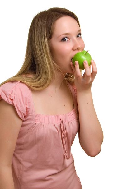 Young beautiful girl eats a green apple - Photo, Image