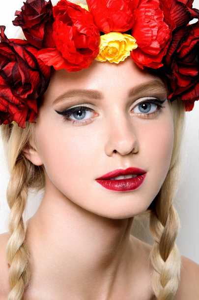 Beautiful girl with a wreath of flowers on her head. - Fotó, kép